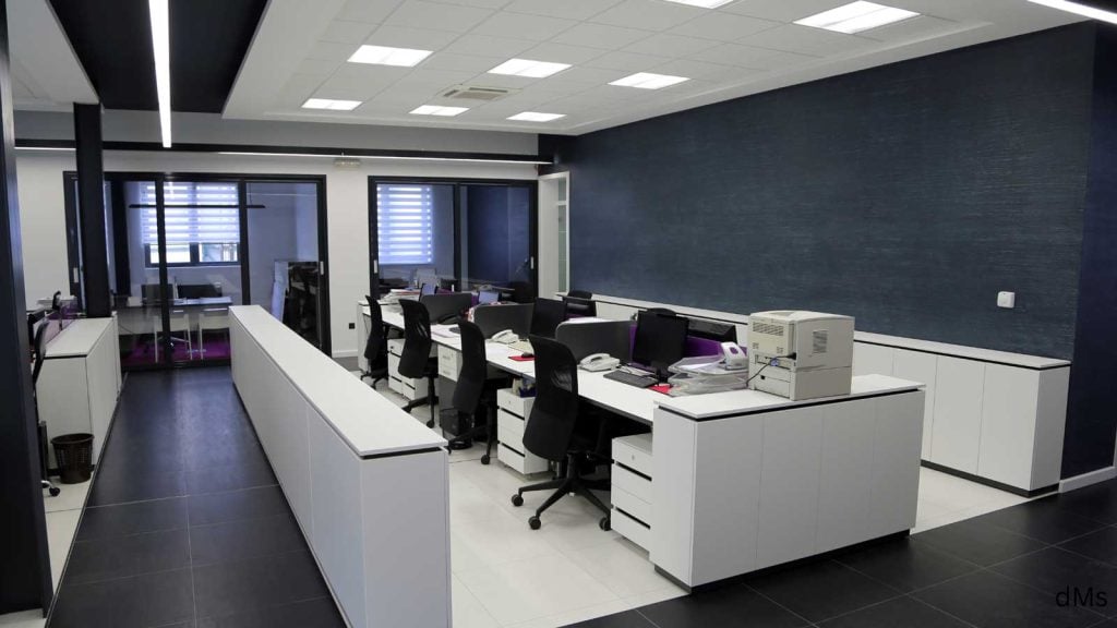 Sleek white office desks in renovated space