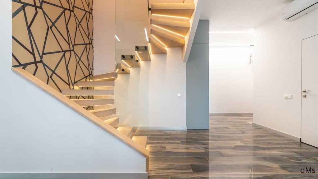 LED-lit modern wooden staircase with geometric wall
