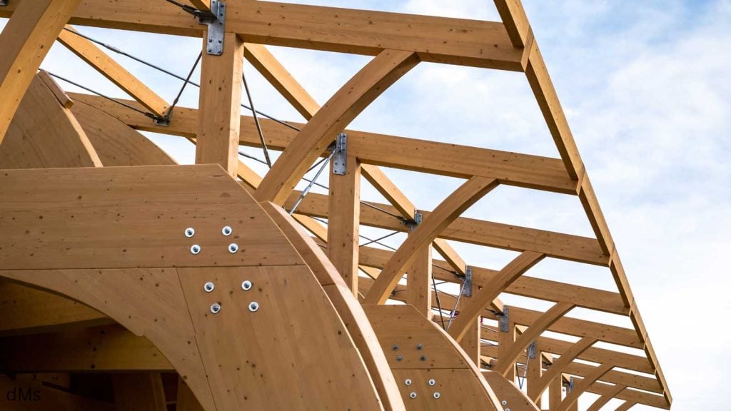 Arched wooden beam trusses in outdoor construction