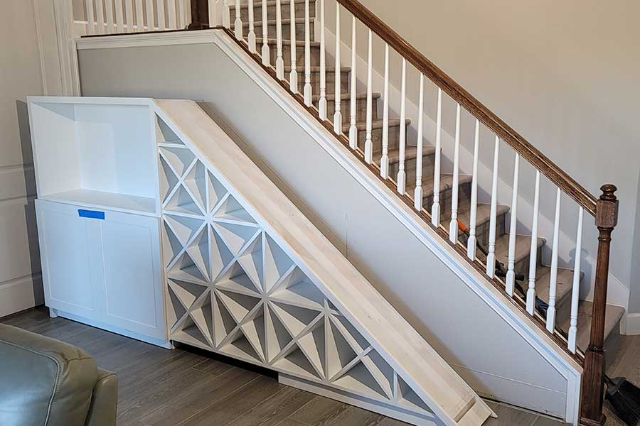 Geometric white slide beside wooden staircase